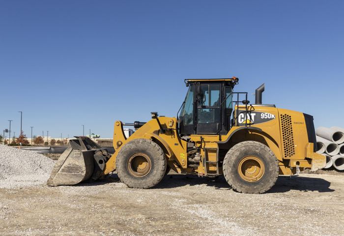 A Caterpillar 950K wheel loader with its bucket raised