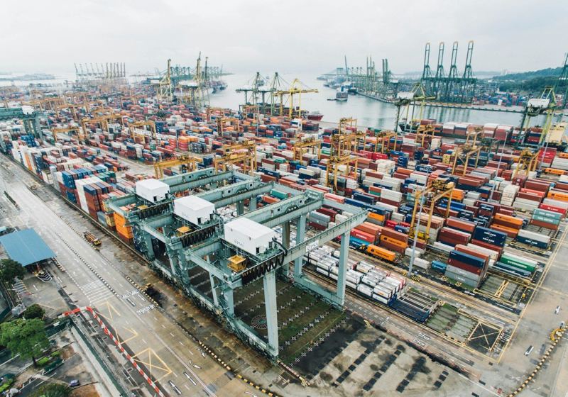 Aerial view of a container port with stacked freight containers and cranes